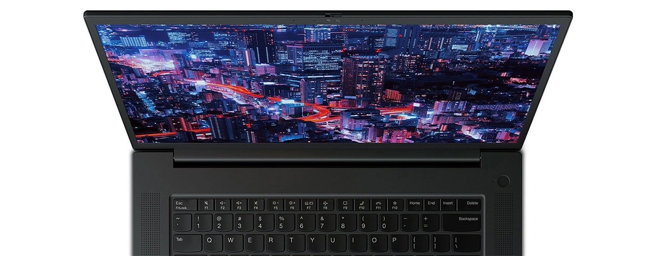 Close up of forward-facing Lenovo ThinkPad P1 Gen 6 (16″ Intel) mobile workstation, opened, showing part of keyboard & display with a night skyscraper scene