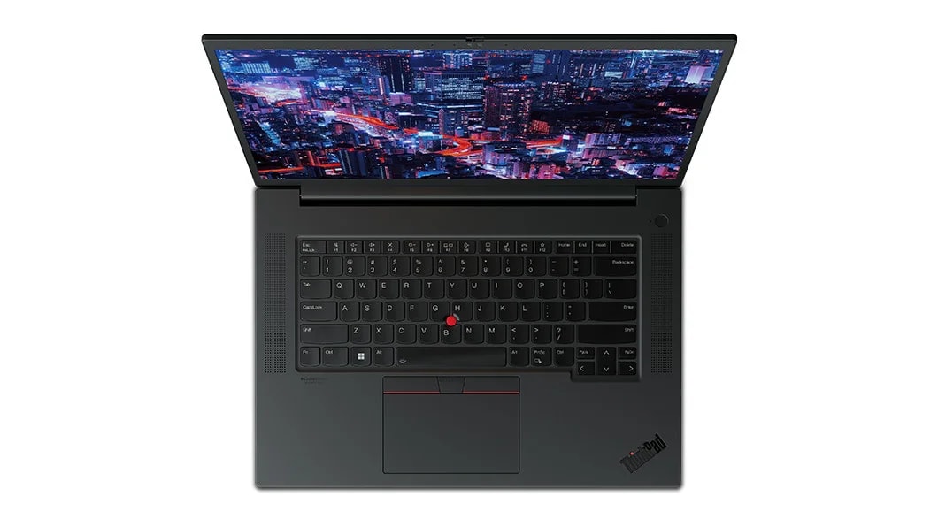 Aerial view of forward-facing  Lenovo ThinkPad P1 Gen 6 (16, Intel) mobile workstation, opened, showing full keyboard & display with a night skyscraper scene