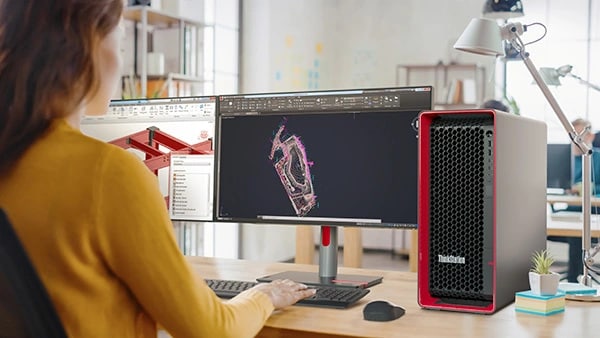 Ein Designer betrachtet technische Zeichnungen auf zwei Monitoren, während er auf einer Tastatur tippt, rechts daneben steht eine Lenovo ThinkStation P8 Workstation