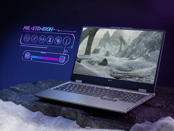 Lenovo LOQ 15IAX9 gaming laptop – right-front view, lid open with arctic scene on the display and MIL-STD 810H graphic to the side