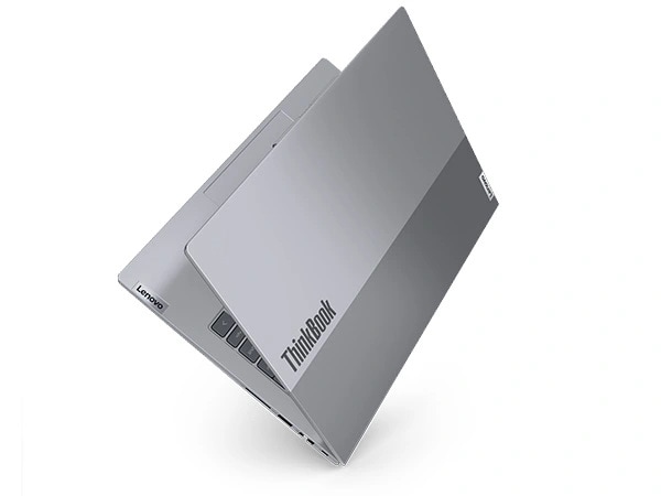 Rear, right side, slant view of Lenovo ThinkBook 14 Gen 7 (14 inch Intel) laptop opened in a V shape, focusing its top cover & the ThinkBook logo on it.