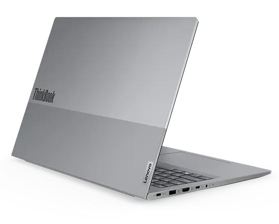 Rear, left side view of Lenovo ThinkBook 16 Gen 7 (16 inch Intel) laptop opened at an acute angle, focusing its top cover & five visible ports.