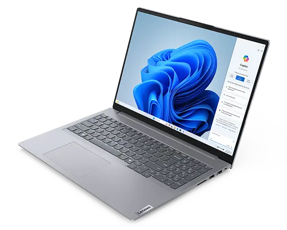 Front, right side view of Lenovo ThinkBook 16 Gen 7 (16 inch Intel) laptop opened at a wide angle, focusing its keyboard & a Windows Copilot menu opened on the right side of the screen.