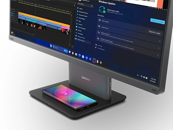 Lenovo ThinkCentre Neo 50a G5 27″all-in-one desktop PC -- front-right view with a  closeup, showing the base wirelessly charging a mobile phone.
