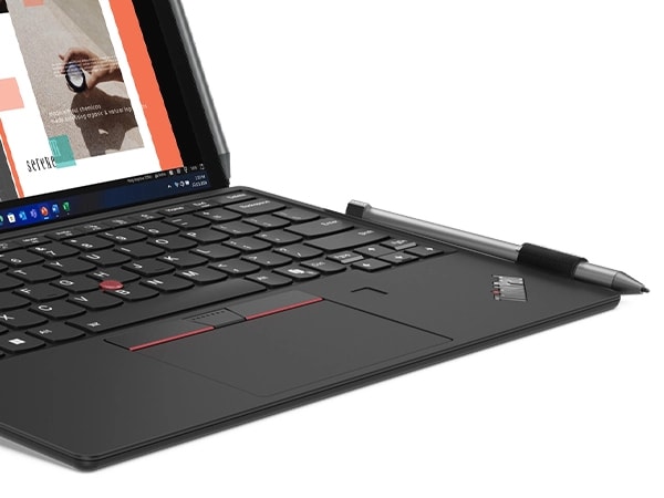 A close-up shot of the Lenovo ThinkPad X12 Detachable Gen 2 notebook computer, showing the keyboard and stylus.