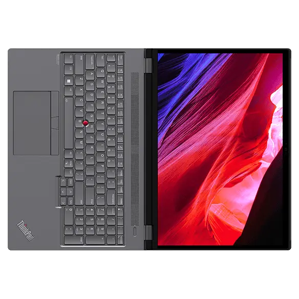 Aerial view of Lenovo ThinkPad P16 Gen 2 (16″ Intel) laptop, laid flat, opened 180 degrees, showing display with swirly designs on screen, plus keyboard