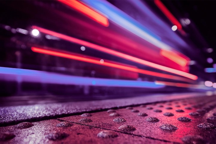 A time lapse of red, purple, and blue lights on the street