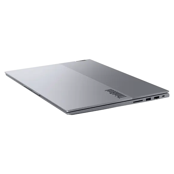 Right side view of Lenovo ThinkBook 16 Gen 7 (16 inch Intel) laptop with lid closed, slightly tilted towards the right, focusing its top cover with a highlighted ThinkBook logo.