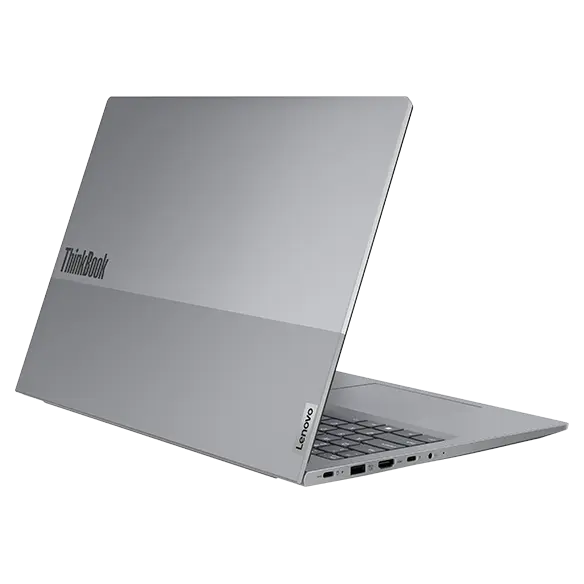 Rear, left side view of Lenovo ThinkBook 16 Gen 7 (16 inch Intel) laptop opened at an acute angle, focusing its top cover & five visible ports.