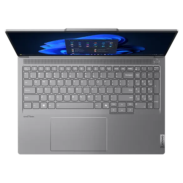 Top view of the Lenovo ThinkBook 16p Gen 5 (16” Intel) laptop with lid opened at a wide angle, a Windows 11menu displayed on screen, & a clear view of its keyboard.