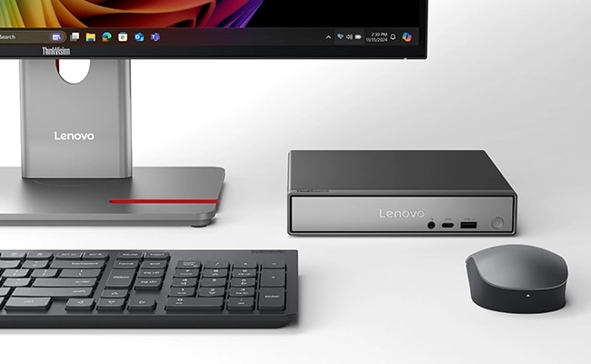 The Lenovo ThinkCentre Neo 50q (Snapdragon) Tiny PC in a setup combined with a wireless keyboard & mouse, boasting its multi-device support to cater to modern-day needs.