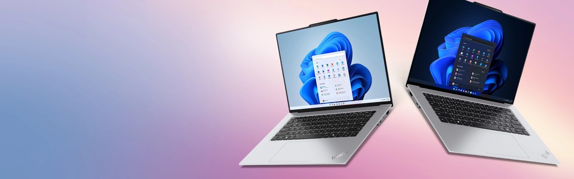 ディスプレイにWindowsのブルームが表示された2台のLenovo ThinkPadノートPC。