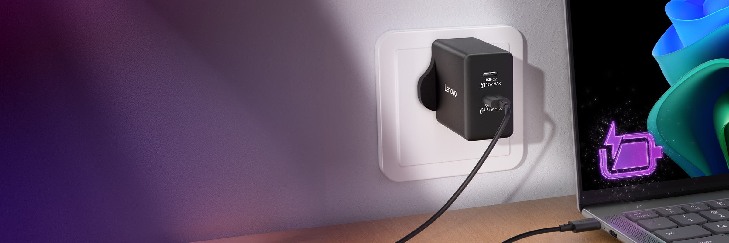 Lenovo 65W GaN wall charger plugged into a socket, connected to a laptop showing a charging icon, with a purple ambient light effect.