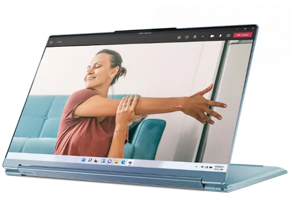 Lenovo Yoga 9i in presentation mode, showing a lady doing yoga at home.