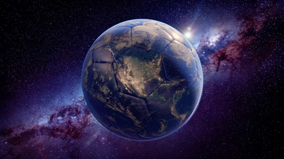 Earth shaped like a soccer ball floating in space with stars and a glowing galaxy backdrop.