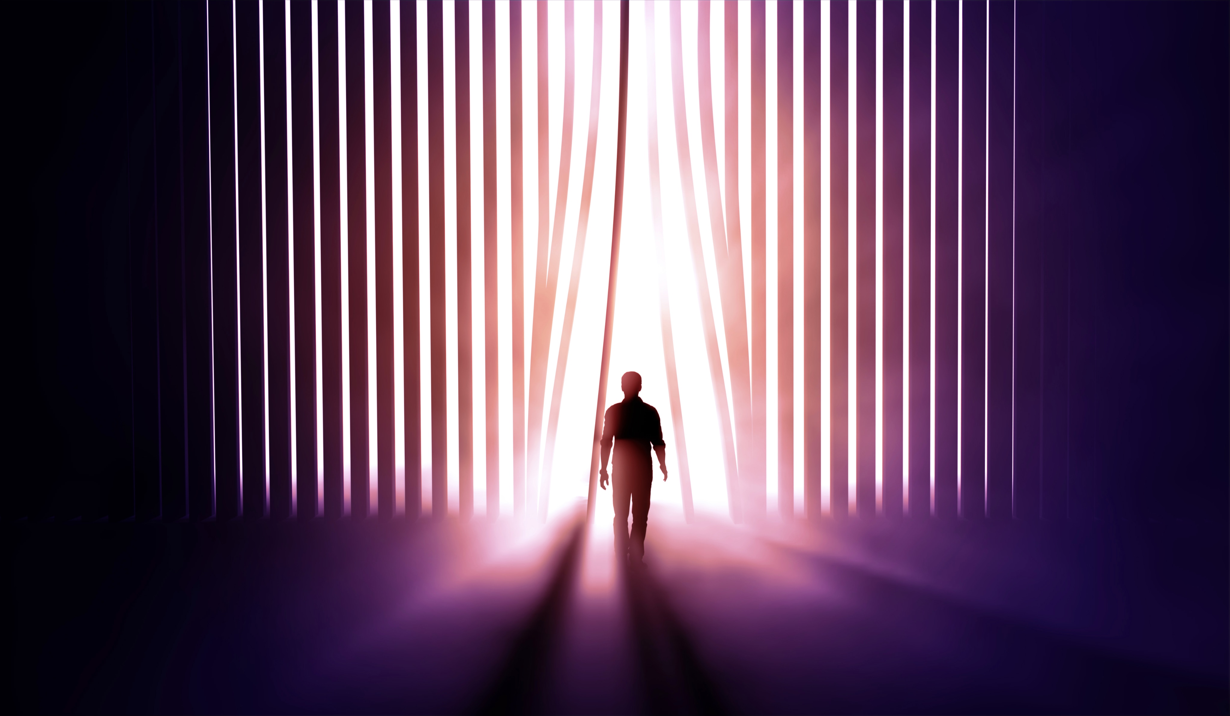 Silhouette of a person walking toward bright light shining behind vertical curtain slats.