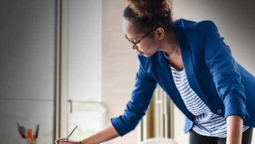 Woman standing at desk working