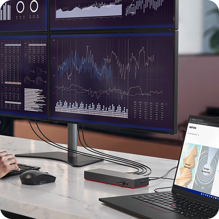 In the office, a person is using the dock which supports four 4K displays to analyze the data. 