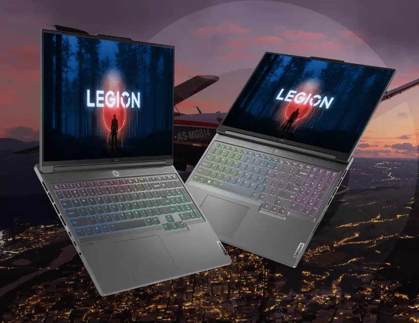 Two Lenovo Legion Slim series laptops sitting in a smoky city ruin.
