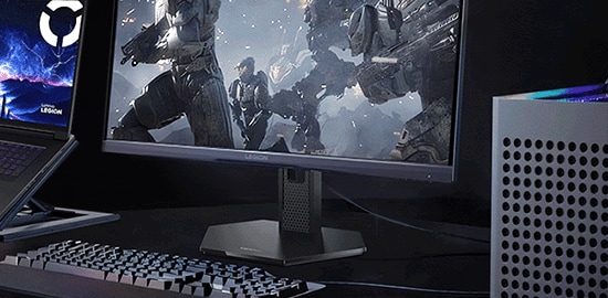 Legion gaming monitor seamlessly connected with desktop tower, laptop, and external keyboard for an integrated setup.