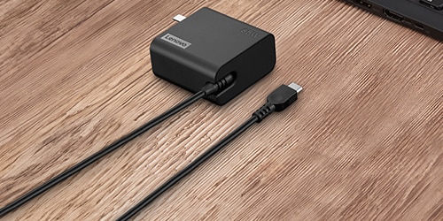 A Lenovo 65W USB-C Wall Adapter-US Pin is featured on a background.