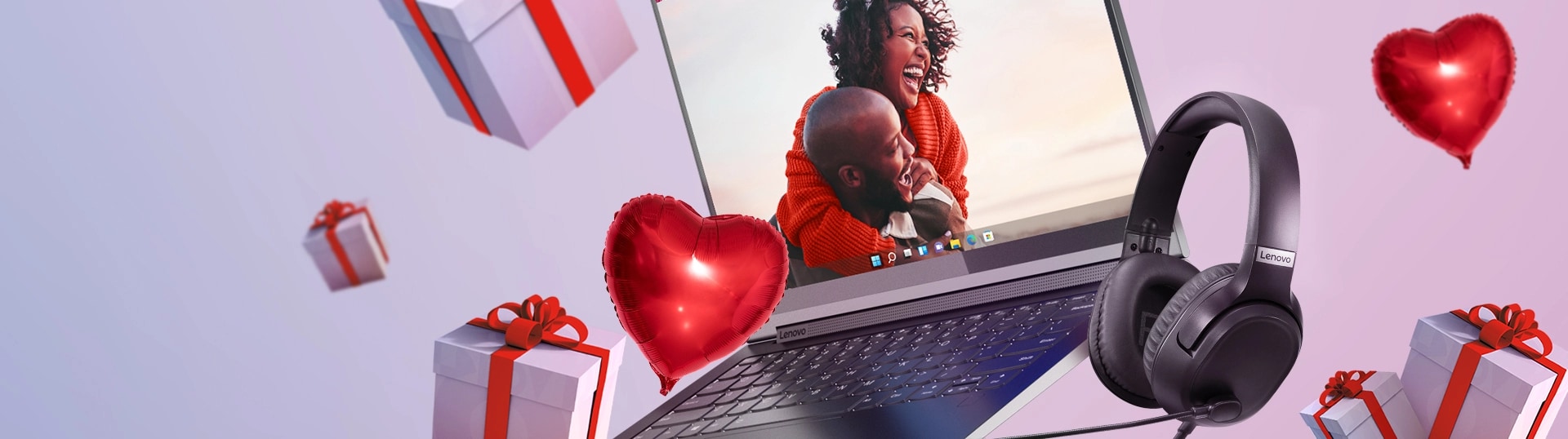 Floating open laptop, heart shaped balloons, and presents