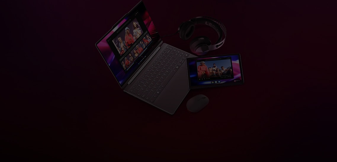 A Lenovo laptop is open, displaying images of people sharing on its screen. Next to it is a tablet also showing the same images, along with Legion headsets and a Lenovo mouse.