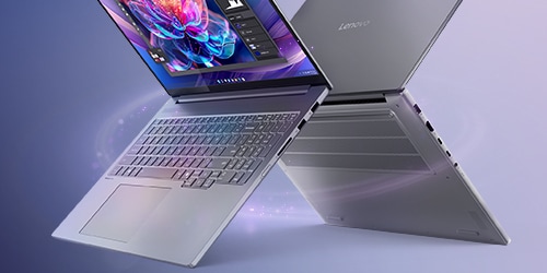 Two Lenovo laptops arranged in an X shape. One laptop is showcasing a vibrant, colorful screen. The background has a smooth gradient blending blue and purple tones, giving the scene a modern and sleek look.