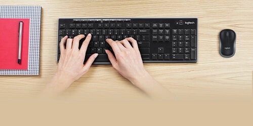 A Logitech keyboard and mouse on a desk.
