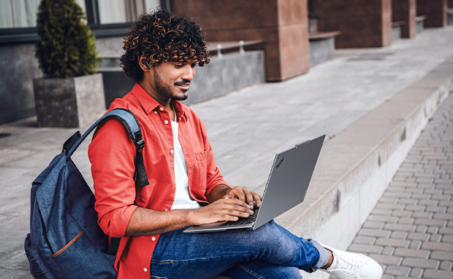 Man using laptop outdoors