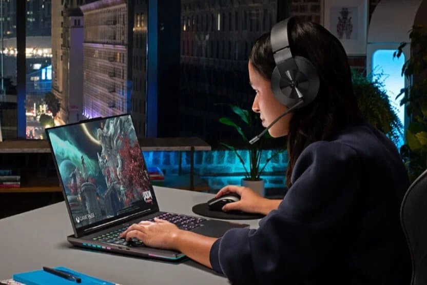 Female gamer wearing Lenovo headset using Lenovo Legion laptop.