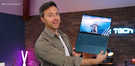 The Tech Chap holds a Lenovo Yoga Slim 7a laptop for the viewer.  