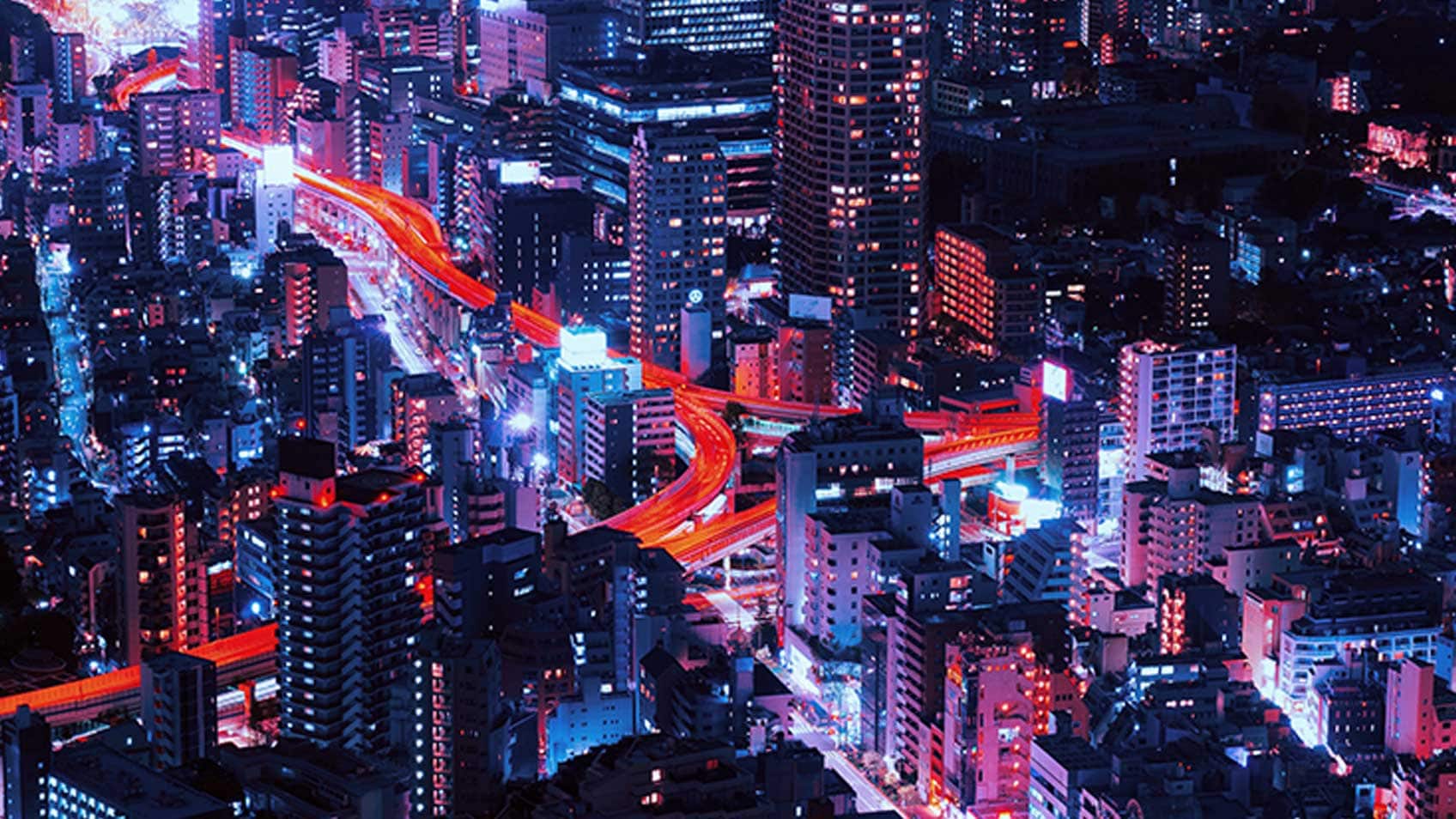 Big city with time-lapse of lights from vehicles flowing through streets