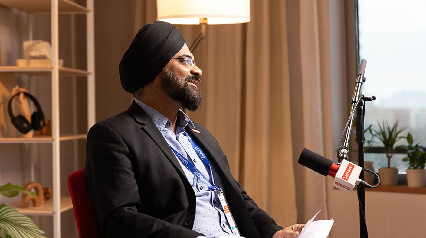 Rakshit Ghura speaking into a Lenovo-branded microphone.