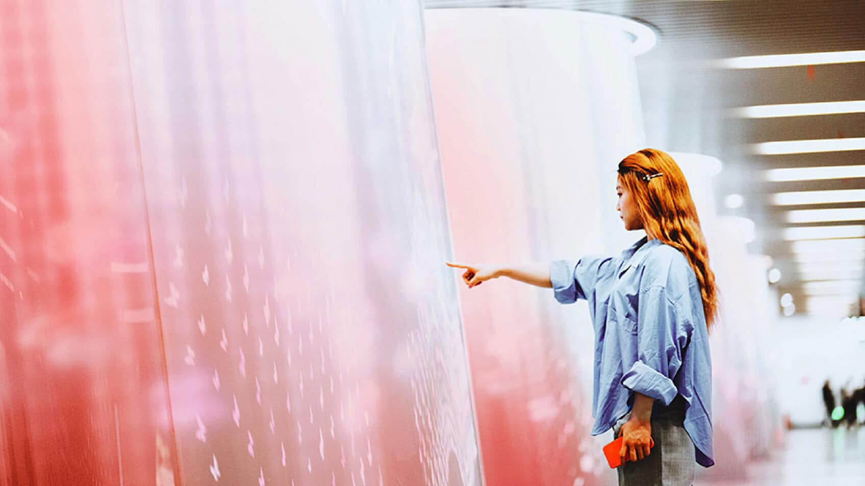 A woman touching an interactive wall