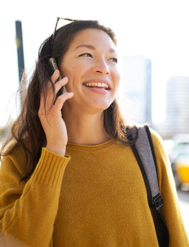 A woman talking outside on a cell phone