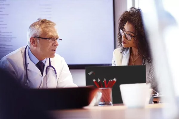 Doctors talking with ThinkPad