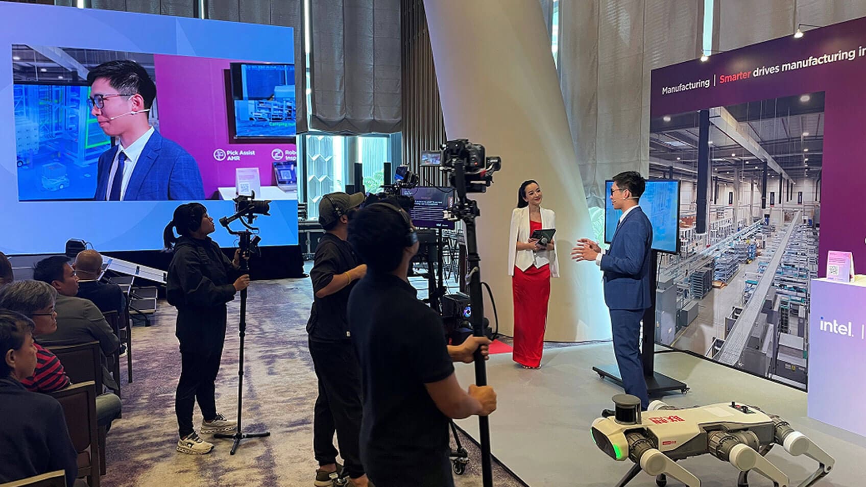 Two people being filmed by a video crew at Tech Day. 