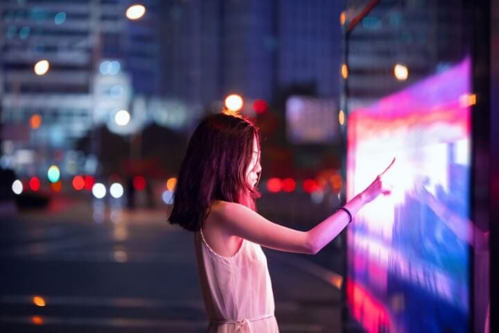 Woman pointing at a digital screen