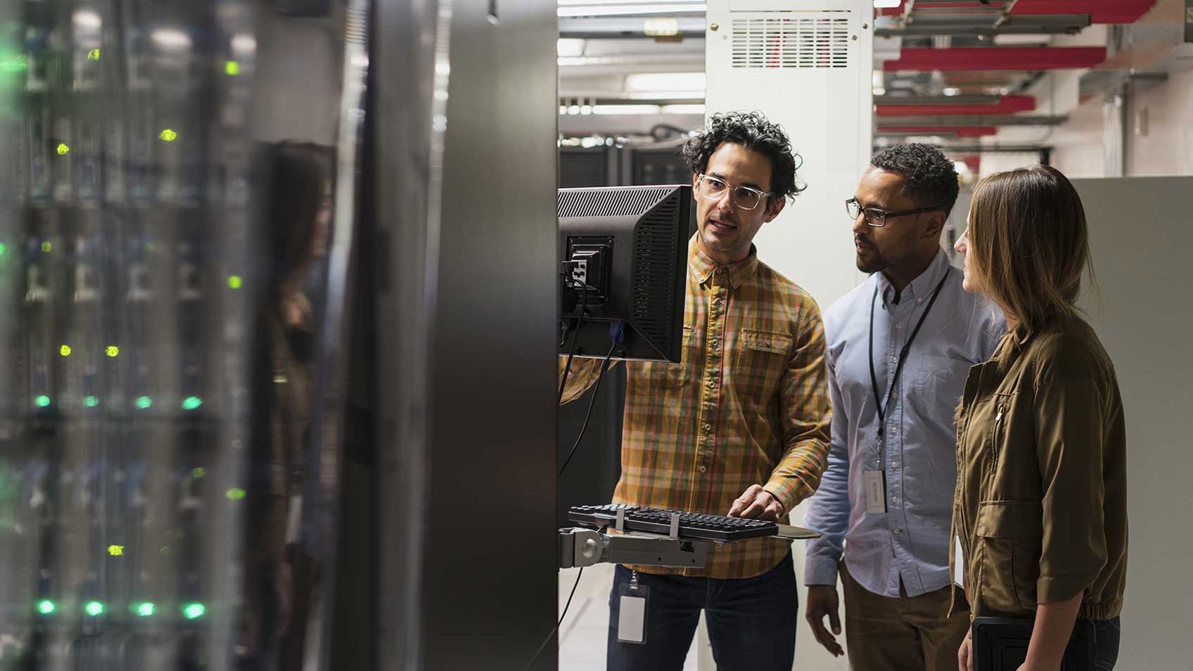 Three colleagues working in a server room