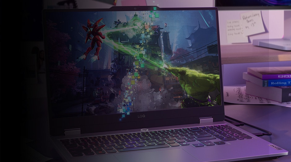 A Lenovo LOQ laptop on a desk next to college textbooks with Marvel Rivals on the screen.