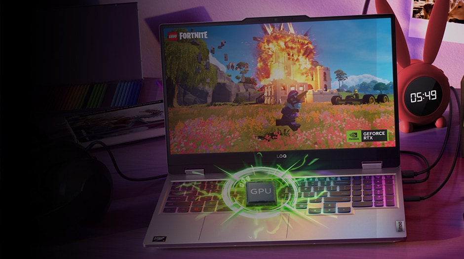 A Lenovo LOQ laptop on a desk with a graphical depiction of the GPU exploding from the device, with Lego Fortnite on the screen.