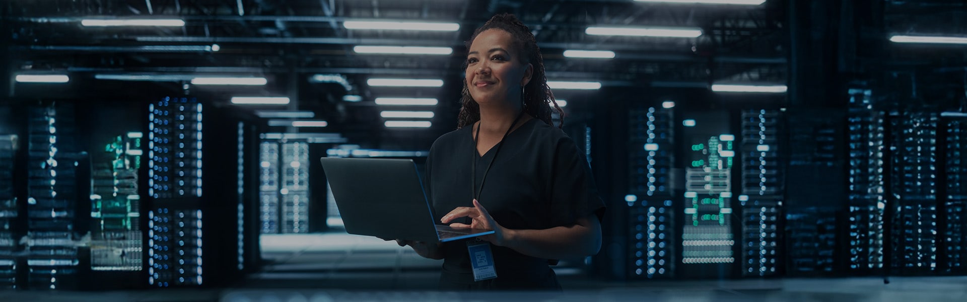 A woman in a red turtleneck using a tablet in a softly lit, futuristic environment.