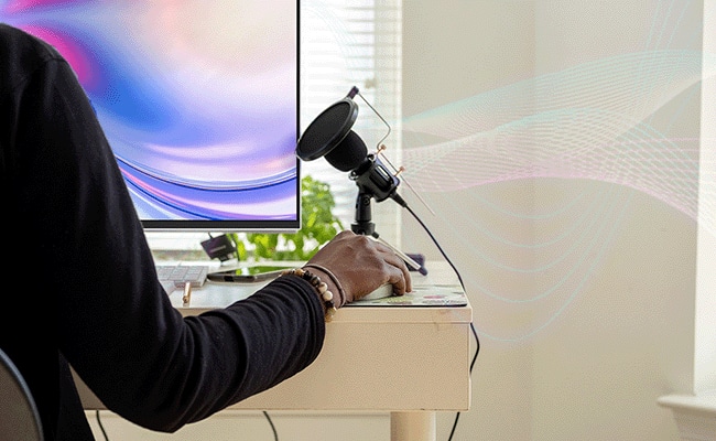 A person enjoys the high-quality audio through the L24-4c monitor’s built-in dual 3W speakers..