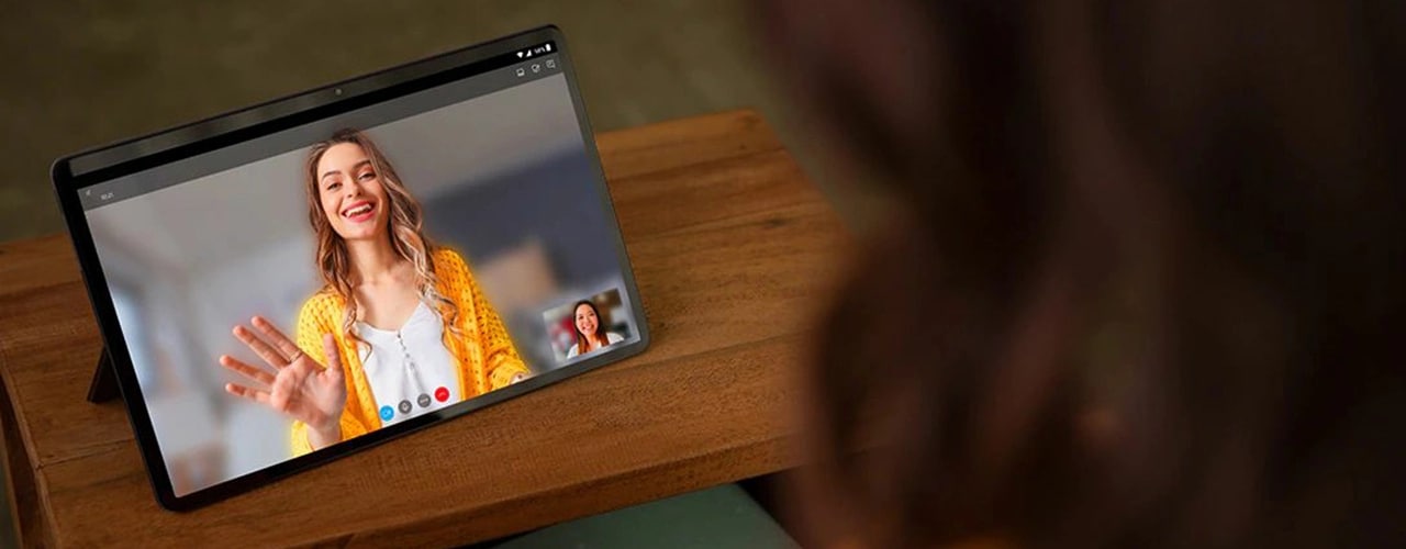 ¾ front view of two hands holding Lenovo Tab P11 tablet horizontally during video call