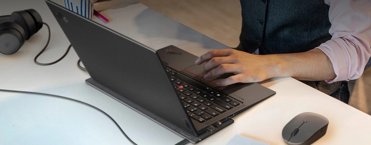 Lenovo Go USB-C Wireless Charging Kit charging a ThinkPad laptop on a tabletop