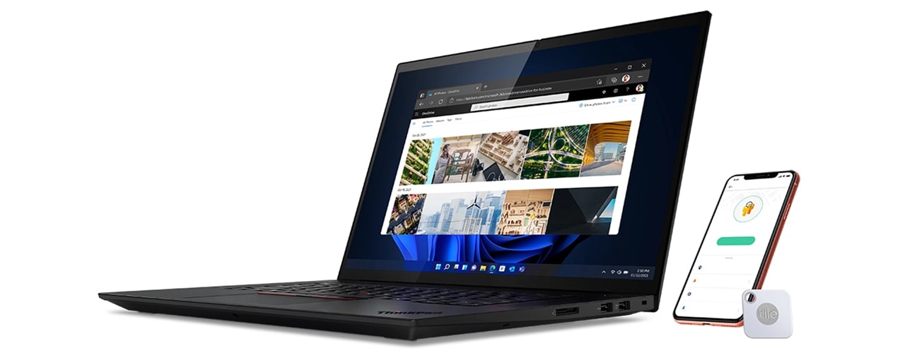 Right-side view X1 Extreme Gen 5 (16” Intel) laptop, opened 90 degrees, next to smartphone, showing Tile security app