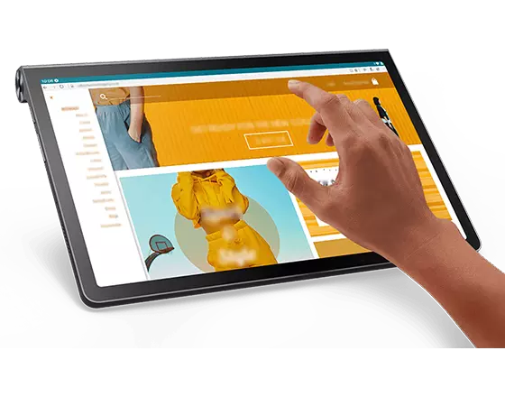 Lenovo Yoga Tab 11 tablet—3/4 left-front view, with online clothing catalog on the display and a person’s right hand about to touch a selection