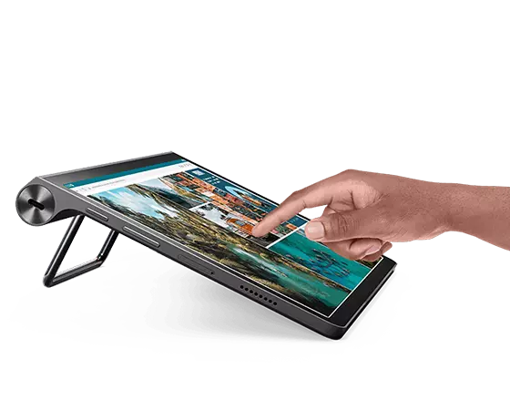 Lenovo Yoga Tab 11 tablet—propped-up left side view with partial view of display and a person’s right hand about to touch an image on the display