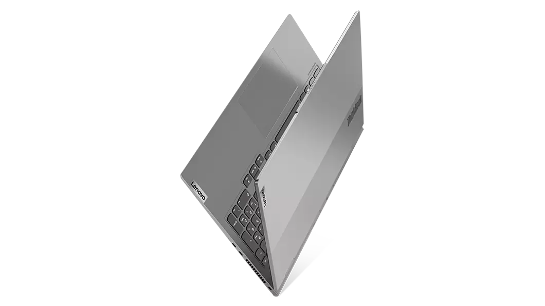 Aerial view of ThinkBook 16p Gen 3 (16, AMD) laptop, balanced on its side, opened 25 degrees in a V-shape, showing part of keyboard and top cover
